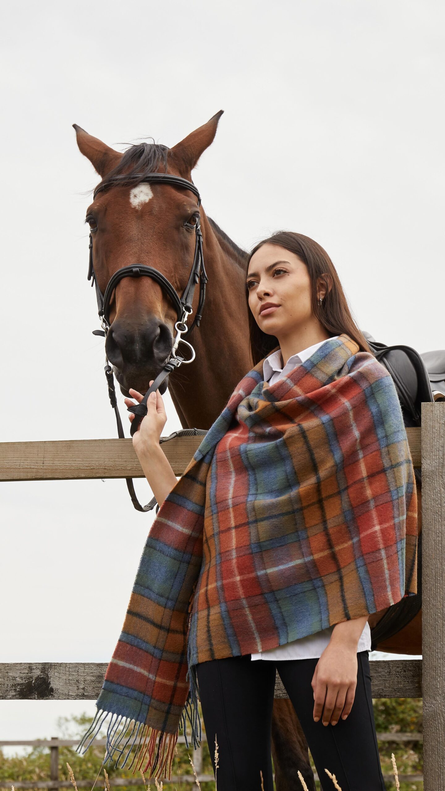 A super-soft and elegant 100% lambswool shawl, available in tartan and plain designs. Lightweight, warm, and versatile, perfect for stylish layering in any season