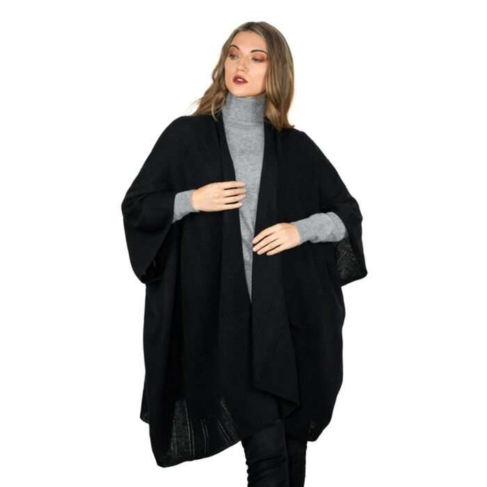 Womens Cashmere Cape with pockets, a soft cashmere cape made from 100% cashmere and detailed, functional pockets. Model wearing black