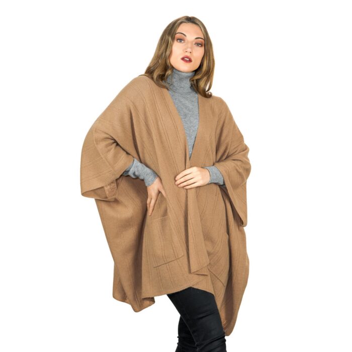 Womens Cashmere Cape with pockets, a soft cashmere cape made from 100% cashmere and detailed, functional pockets. Model wearing camel