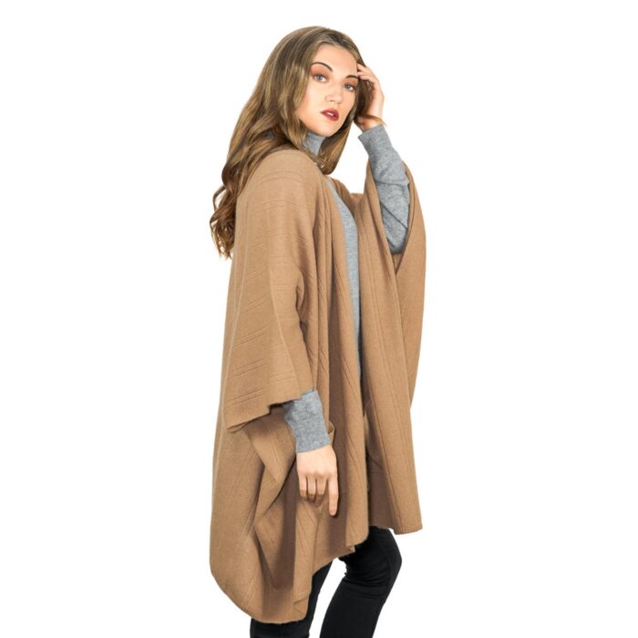 Womens Cashmere Cape with pockets, a soft cashmere cape made from 100% cashmere and detailed, functional pockets. Model wearing camel