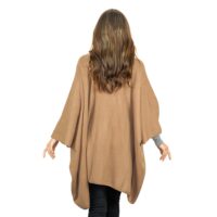 Womens Cashmere Cape with pockets, a soft cashmere cape made from 100% cashmere and detailed, functional pockets. Model wearing camel