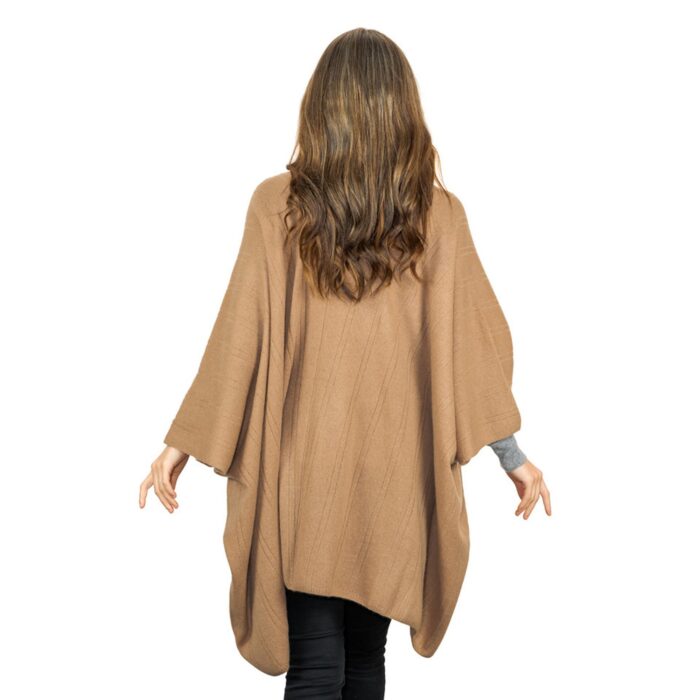 Womens Cashmere Cape with pockets, a soft cashmere cape made from 100% cashmere and detailed, functional pockets. Model wearing camel