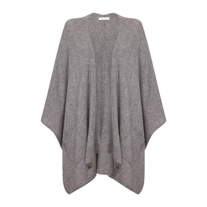 Womens Cashmere Cape with pockets, a soft cashmere cape made from 100% cashmere and detailed, functional pockets. Model wearing Grey