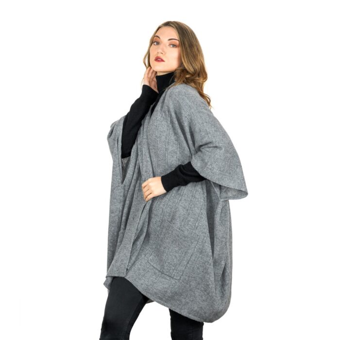 Womens Cashmere Cape with pockets, a soft cashmere cape made from 100% cashmere and detailed, functional pockets. Model wearing Grey