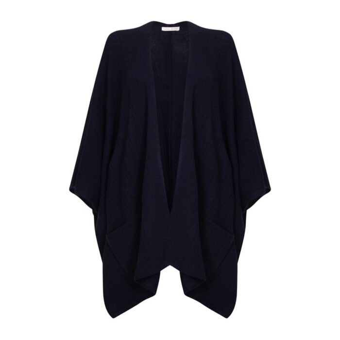 Womens Cashmere Cape with pockets, a soft cashmere cape made from 100% cashmere and detailed, functional pockets. Model wearing navy