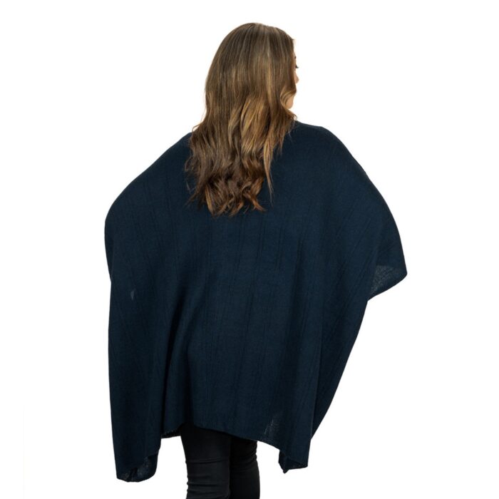 Womens Cashmere Cape with pockets, a soft cashmere cape made from 100% cashmere and detailed, functional pockets. Model wearing navy