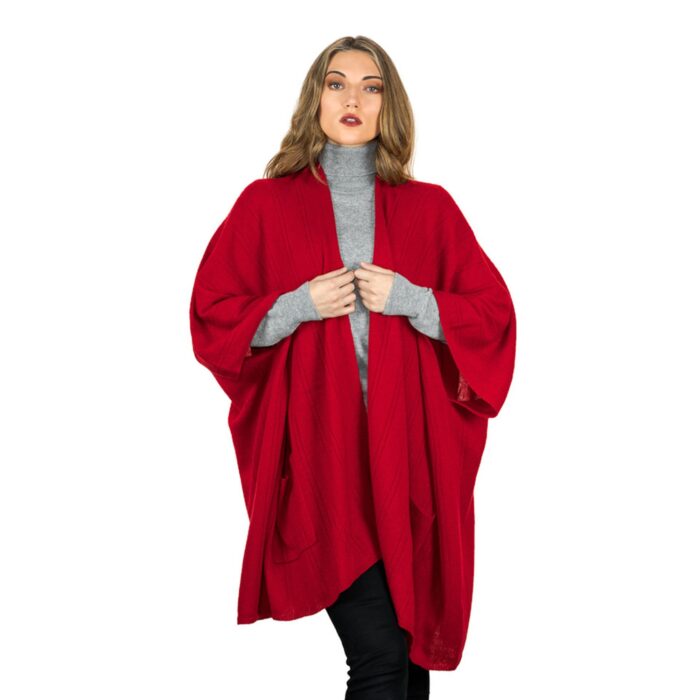 Womens Cashmere Cape with pockets, a soft cashmere cape made from 100% cashmere and detailed, functional pockets. Model wearing red