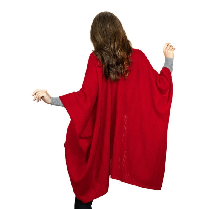 Womens Cashmere Cape with pockets, a soft cashmere cape made from 100% cashmere and detailed, functional pockets. Model wearing red