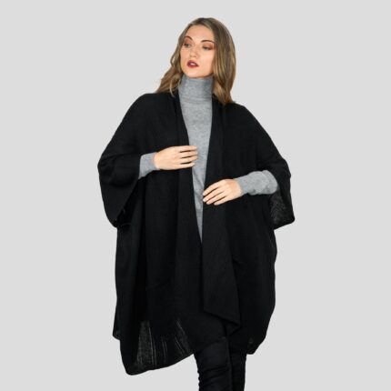 Womens Cashmere Cape with pockets, a soft cashmere cape made from 100% cashmere and detailed, functional pockets. Model wearing Black