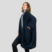 Womens Cashmere Cape with pockets, a soft cashmere cape made from 100% cashmere and detailed, functional pockets. Model wearing Navy