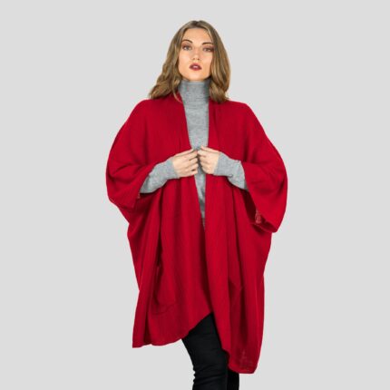 Womens Cashmere Cape with pockets, a soft cashmere cape made from 100% cashmere and detailed, functional pockets. Model wearing Red
