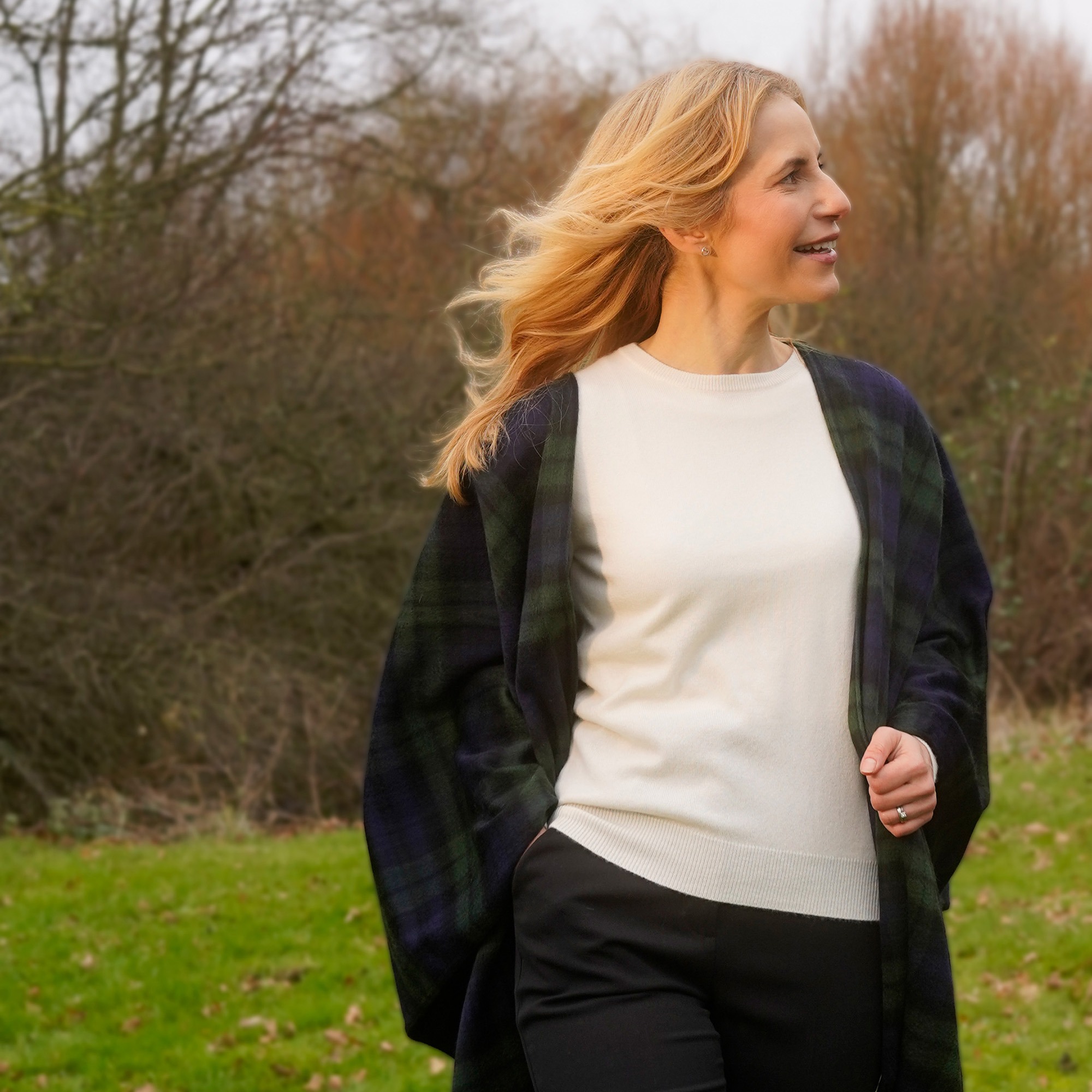 A stylish and elegant round neck jumper in White, paired with our Black Watch Ruana