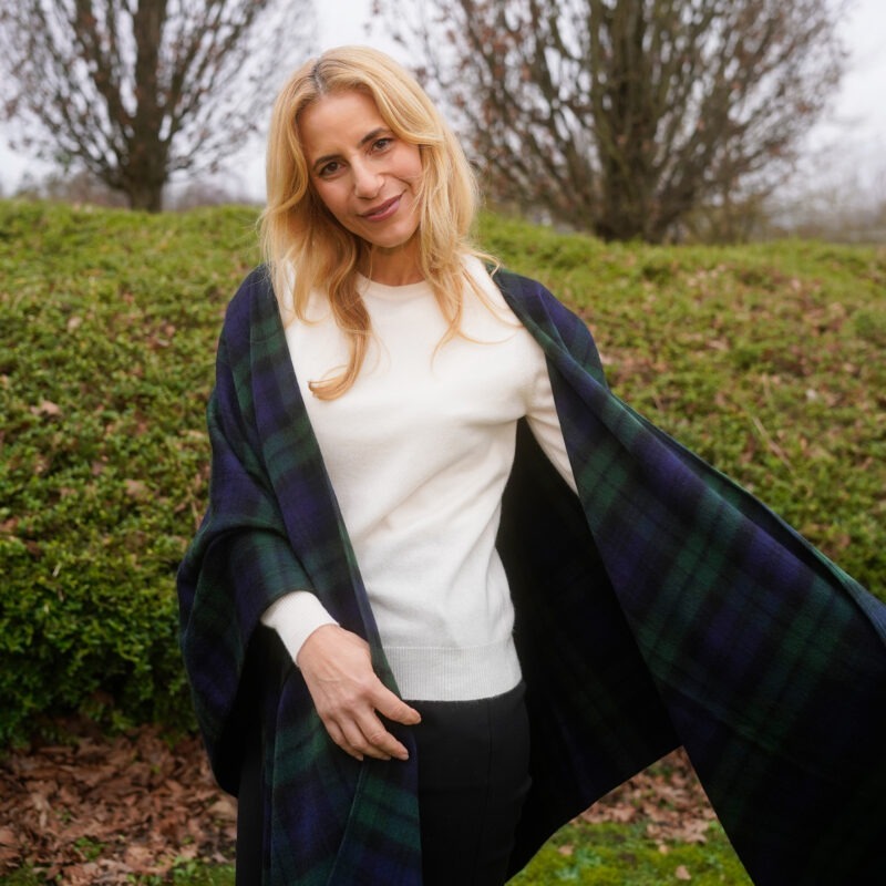 Model wearing Lona Scott Women's 100% Cashmere Round-Neck Jumper in white, with a stylish Black Watch Tartan Ruana, for an elegant look