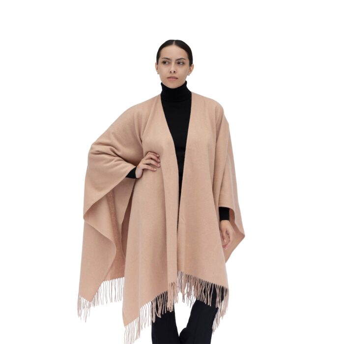 Model Wearing a Women's Lambswool Ruana Cape, a soft cashmere cape in a Soft Camel Colour