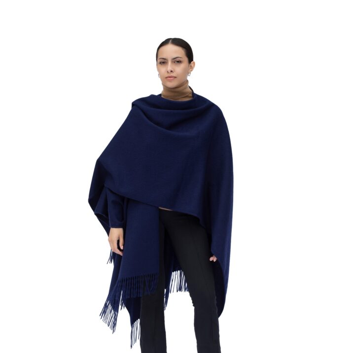 Model Wearing a Women's Lambswool Ruana Cape, a soft lambswool cape in a Navy Colour