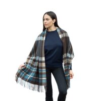 Model wearing Lona Scott Cashmere Shawl, in a patterned blue and brown