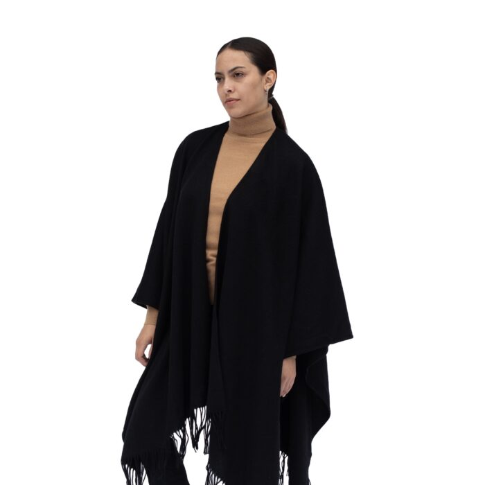 Model wearing Lona Scott Women's Lambswool Ruana Cape, a soft Lambswool cape in Black