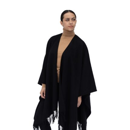 Model wearing Lona Scott Women's Lambswool Ruana Cape, a soft lambswool cape in Black
