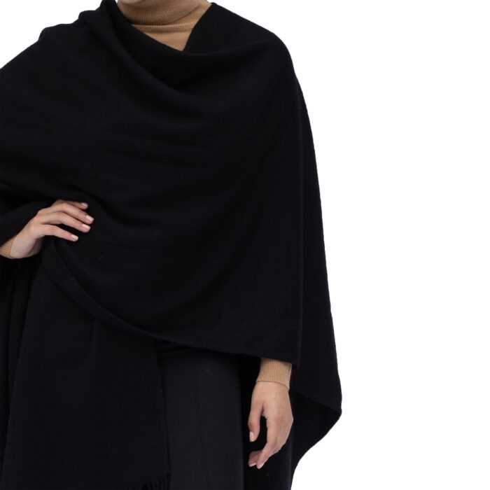 Model wearing Lona Scott Women's Lambswool Ruana Cape, a soft lambswool cape in Black