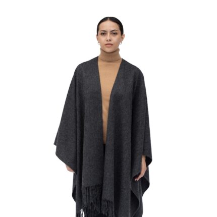 Model wearing Lona Scott Women's Lambswool Ruana Cape, a soft lambswool cape in Charcoal