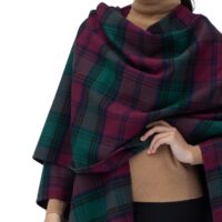 Model wearing Lona Scott Women's Lambswool Ruana Cape, a soft lambswool cape in Lindsay Tartan