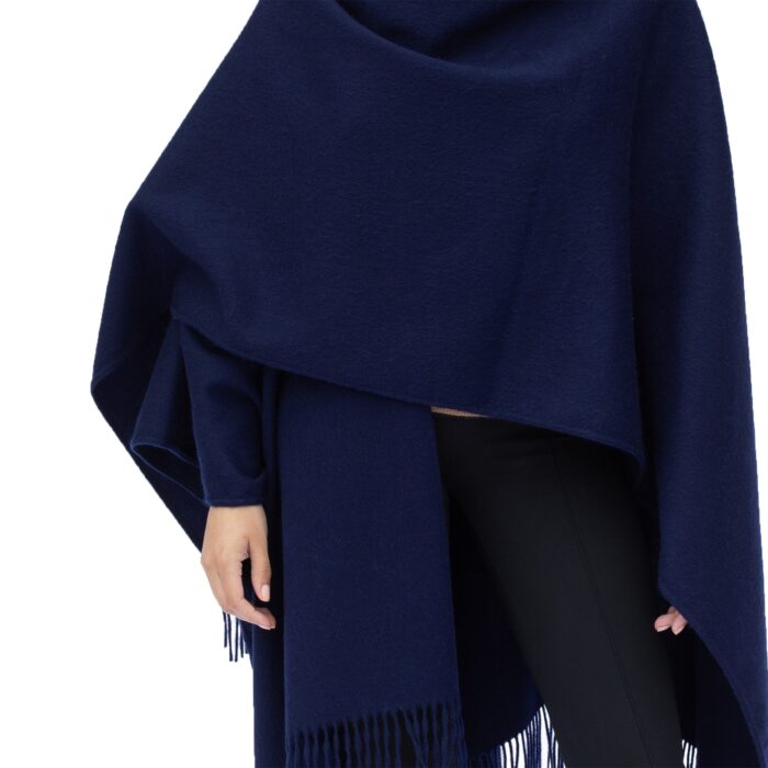 Model wearing Lona Scott Women's Lambswool Ruana Cape, a soft lambswool cape in a Navy