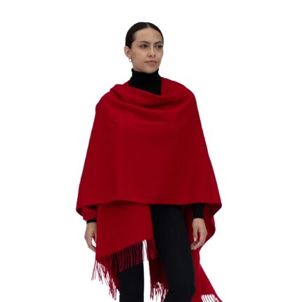 Model wearing Lona Scott Women's Lambswool Ruana Cape, a soft lambswool cape in Red