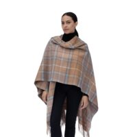 Model wearing Lona Scott Women's Lambswool Ruana Cape, a soft lambswool cape in a Natural Buchanan Tartan