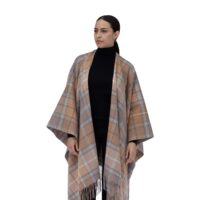 Model wearing Lona Scott Women's Lambswool Ruana Cape, a soft lambswool cape in a Natural Buchanan Tartan