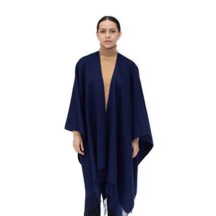 Model wearing Lona Scott Women's Lambswool Ruana Cape, a soft lambswool cape in a Navy