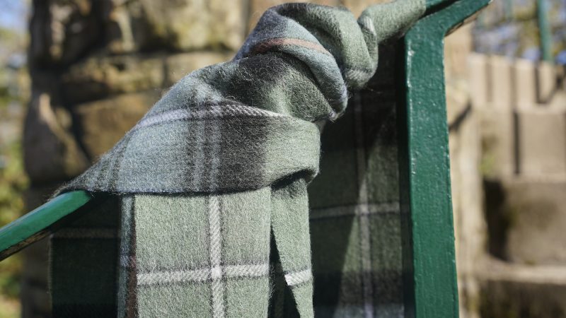 Featuring a rich tartan pattern, this 2-ply Lambswool scarf drapes gracefully with a classic check design and a subtle texture, available in a variety of traditional tartans